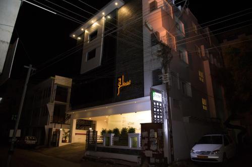 a building with a sign on it at night at Hotel Grand Tree in Coimbatore