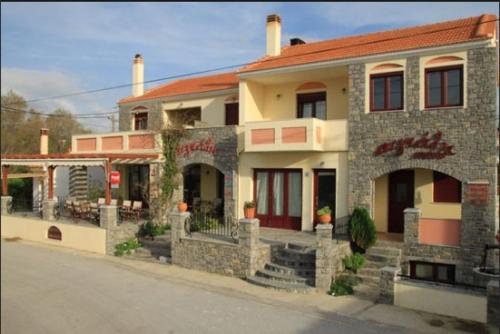 a large stone building with at Aigiali Rooms in Volissos