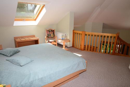 a bedroom with a large bed and a staircase at Residence am Weinberg / Travellers Hotelbetriebs GmbH in Sasbachwalden
