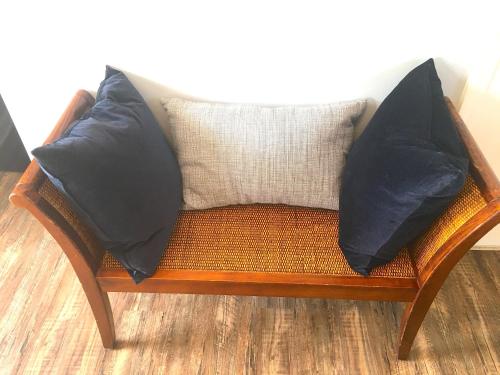 two pillows sitting on a wooden chair at Shorewood Inn in Jamesport