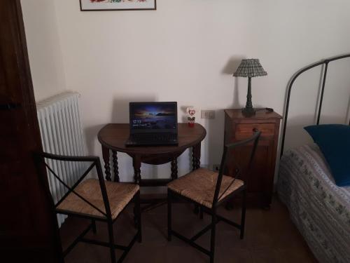 a small table with a laptop on it in a bedroom at Clockwise in Viterbo