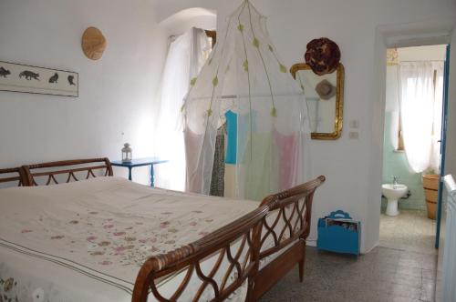 a bedroom with a bed with a canopy at La Casa Torre di Eva in Sarzana