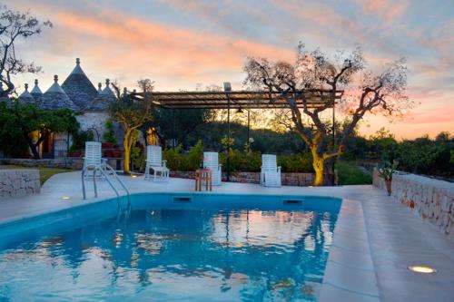 a swimming pool in the backyard of a house at Trullo La Canonica in Martina Franca