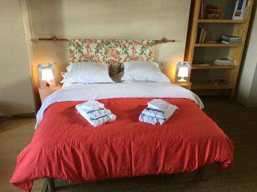 a bedroom with a bed with two towels on it at Coeur De Beaujolais in Corcelles-en-Beaujolais