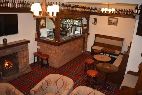 a living room filled with furniture and a fire place at The Sefton Hotel in Bridlington