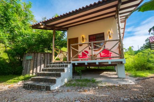 a small house with a staircase leading up to it at Istmo Beach and Jungle Bungalows in San Carlos