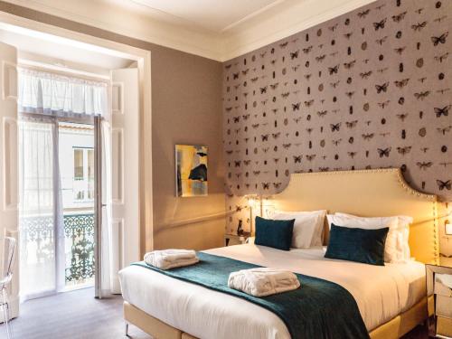 a bedroom with a large bed with a wall at Dear Lisbon - Gallery House in Lisbon