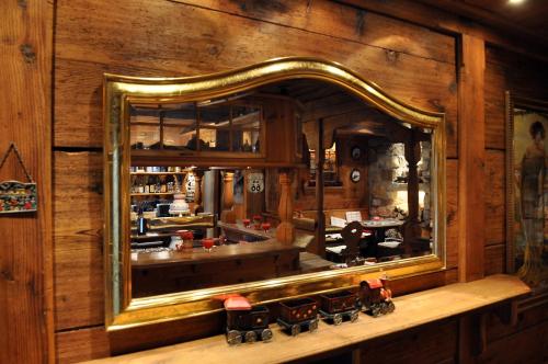 a mirror on a wall with a train in front of it at Hotel Hohenstaufen in Göppingen