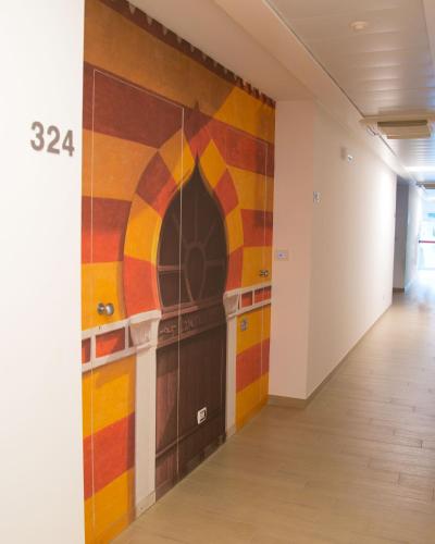 a hallway with a colorful mural on the wall at Est hotel in Santa Cesarea Terme