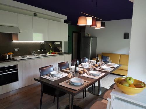a dining room with a table and a kitchen at Lucas Haus in Livigno