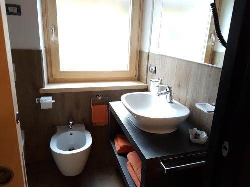 a bathroom with a sink and a toilet at Lucas Haus in Livigno
