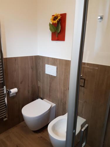 a bathroom with a white toilet and a sink at Lucas Haus in Livigno