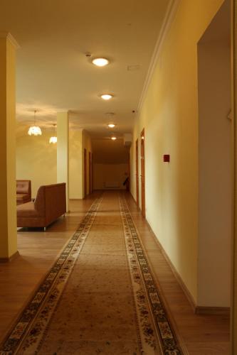 an empty hallway with a rug on the floor at Lucia with Self Check-in in Ludza