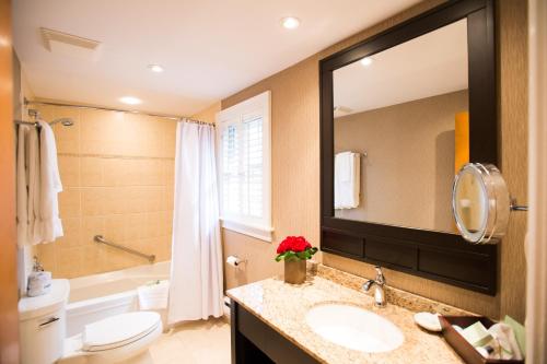 a bathroom with a sink and a toilet and a mirror at Pillar and Post Inn & Spa in Niagara on the Lake