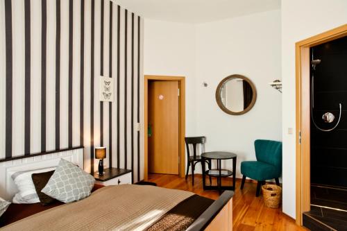 a bedroom with a bed with a striped wall at Pension Oberhof 810 M in Oberhof