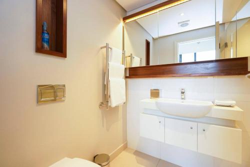 a bathroom with a sink and a mirror at Zimbali Suite 205 in Ballito