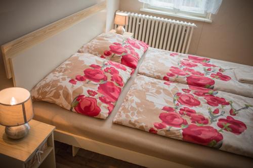a bed with two pillows on top of it at Domcek Miriam in Hrabušice