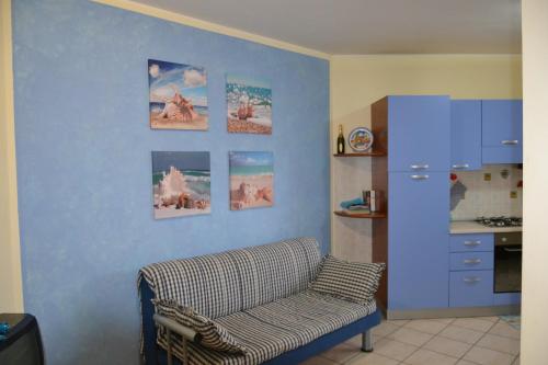 a living room with a couch and pictures on the wall at Case Vacanze Rocca in Bastia Umbra