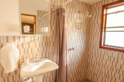 a bathroom with a sink and a shower at Magnific Rock - Surf Resort & Yoga Retreat Nicaragua in Popoyo