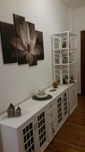a room with a white cabinet with a flower on the wall at Il Posto Giusto in Ciampino