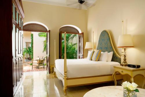 a bedroom with a large bed and a patio at Casa Lecanda Boutique Hotel in Mérida