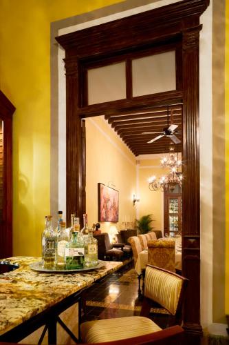 a living room with a table with glasses on it at Casa Lecanda Boutique Hotel in Mérida