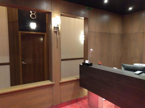 a room with a mirror and a door in a room at Hotel Manoir Morgan in Quebec City