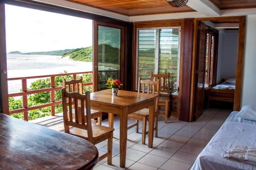 a room with a table and chairs and a balcony at Magnific Rock - Surf Resort & Yoga Retreat Nicaragua in Popoyo
