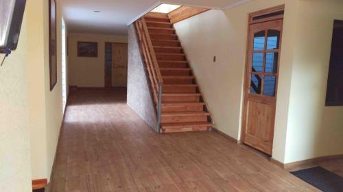 a hallway with a wooden staircase in a house at Hostal Sol de Atacama in Copiapó