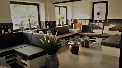 a living room with couches and a table at DF am Ring Nürburg in Nürburg