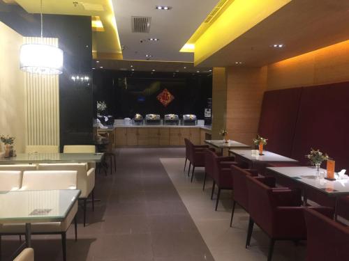a dining room with tables and chairs and a bar at Jinjiang Inn Tianjin Changjiangdao in Tianjin