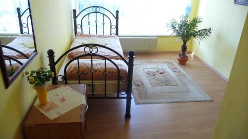 a bedroom with a metal bed and a rug at Hotel Štadión in Košice