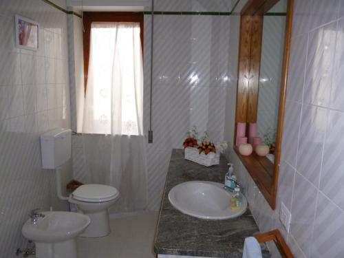 a bathroom with a sink and a toilet and a mirror at B&B Le Grand Bleu Siracusa - One Hundred Steps From Ortigia -Sea View - in Siracusa