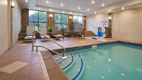 una piscina en una habitación de hotel con un restaurante en Best Western Plus Concordville Hotel, en Concordville