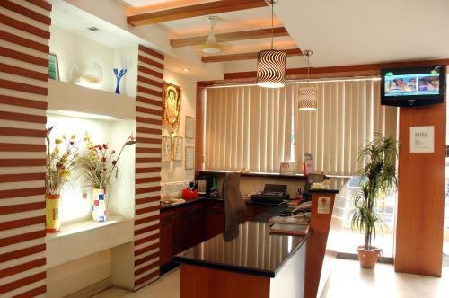 a kitchen with a counter and a television in it at Hotel Imperial Classic in Hyderabad