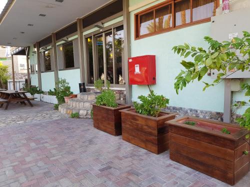 a building with a red box on the side of it at Arava Hostel in Eilat
