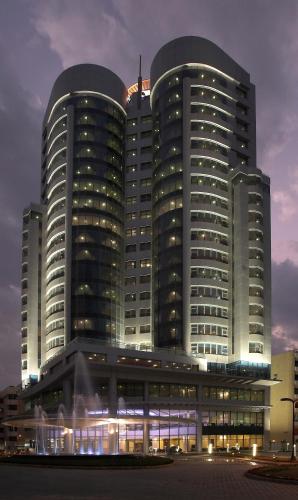 a large building with many windows in front of it at Costa Del Sol Hotel by Arabian Link in Kuwait