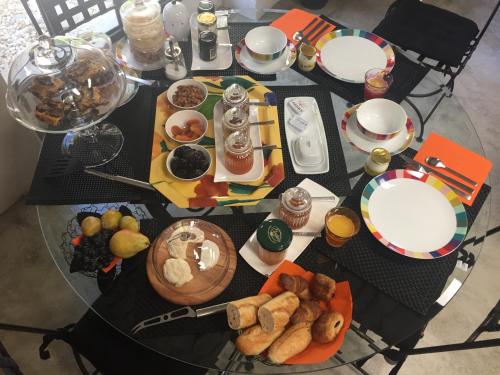 a glass table with plates of food on it at le mas de colongene in Faucon