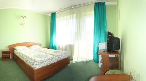 a bedroom with a bed and a window with blue curtains at Laguna in Slavske