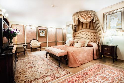 a bedroom with a large bed with a canopy at Hotel Marinela Sofia in Sofia