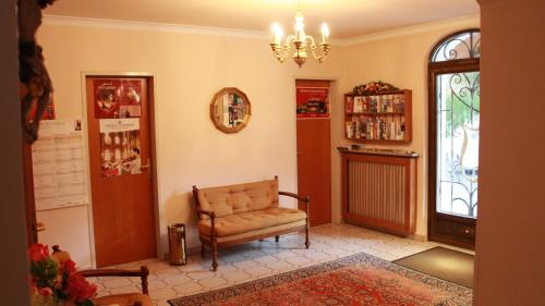 a living room with a chair and a chandelier at Hotel Josefa in Salzburg