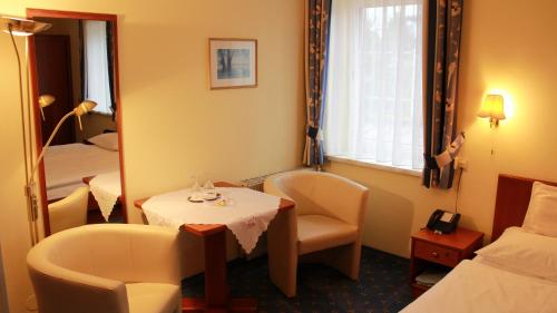 a hotel room with a table and a mirror at Hotel Josefa in Salzburg