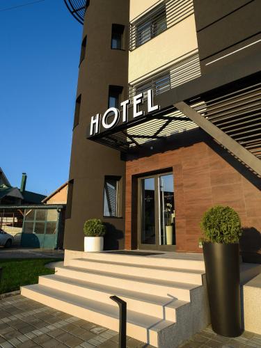 a hotel sign on the front of a building at Hotel Ideo Lux in Niš