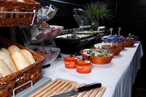 
a table topped with a variety of food items at Hotel La Reine in Eindhoven
