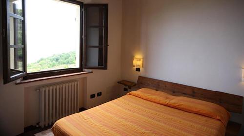 Кровать или кровати в номере Agriturismo San Quirico