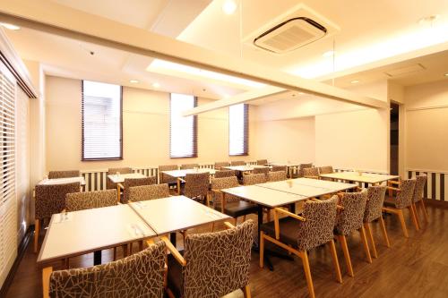 an empty dining room with tables and chairs at Takamatsu Tokyu REI Hotel in Takamatsu