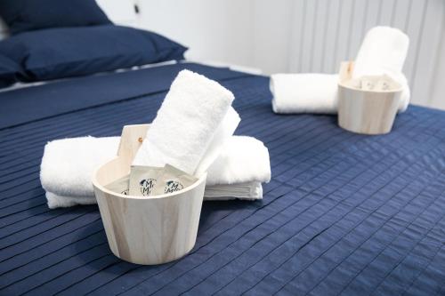 a blue bed with towels and towels on it at Moi Moi B&B in LʼAquila