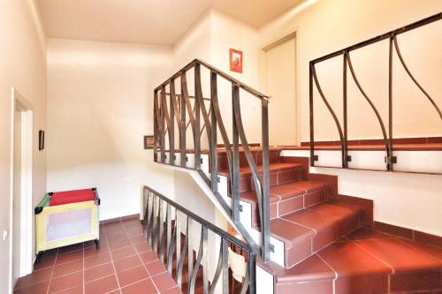 a staircase in a home with red tile floors and a stair case at Teghenis Resort in Tsaghkadzor