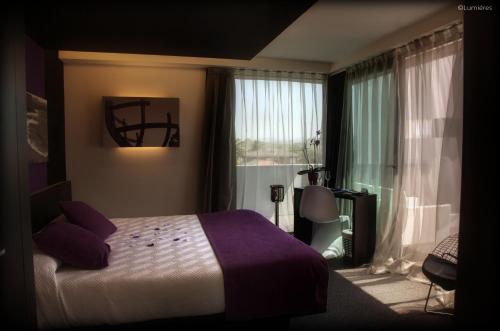 a hotel room with a bed and a window at Hotel Playa Ribera in Suances