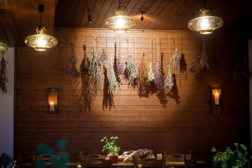 a wall with lights and dried flowers on it at Kräuterhotel Edelweiss in Rigi Kaltbad
